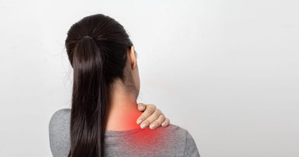 Woman holding her shoulder in pain